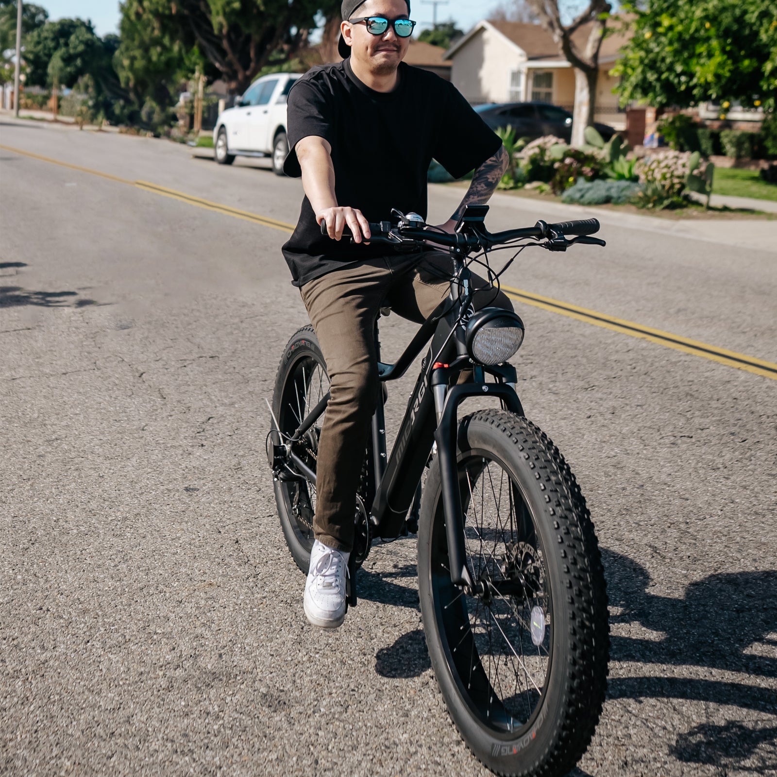 Side view of Micargi Steed Electric Mountain Bicycle fat tire riding in the city
